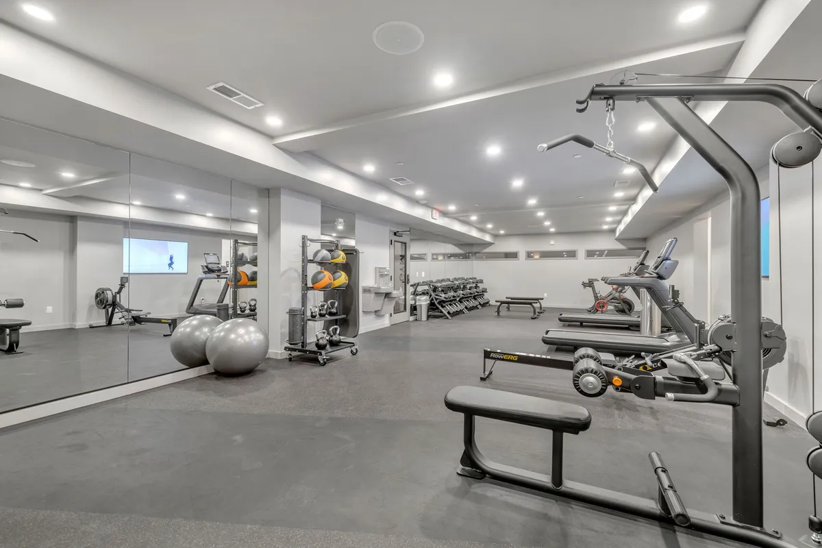 A well-equipped, modern fitness center featuring exercise machines, gym balls, and mirrored walls. The clean, energetic setting invites guests to pursue personal fitness goals or join group classes.