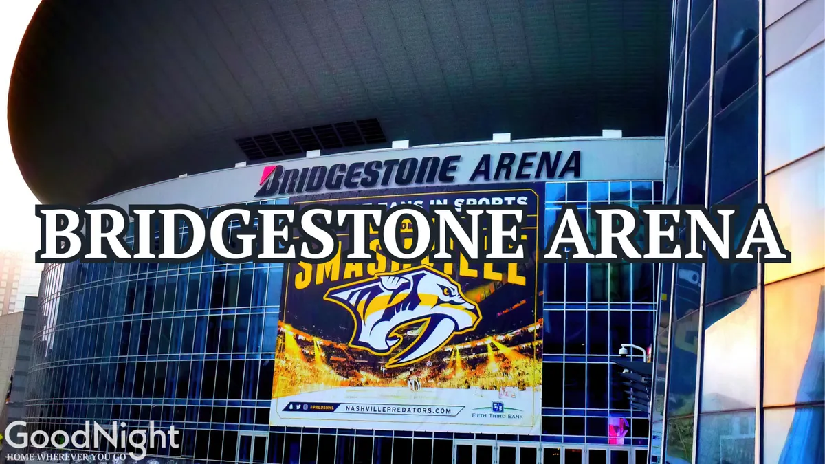 The exterior of Bridgestone Arena, featuring its recognizable signage and a large Nashville Predators banner, stands out as an iconic downtown landmark. The modern design and event banners hint at concerts, sports events, and community gatherings.